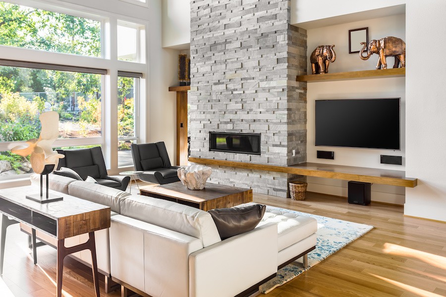 A luxurious, open living room space with a couch and wall-mounted TV.