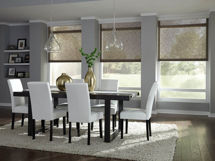 A dining room space featuring Lutron motorized shades lowered halfway.